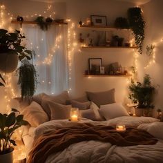 a bedroom with lights and plants on the wall above the bed is lit up by candles