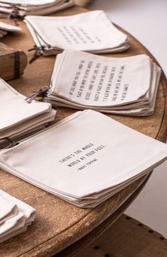 several napkins with writing on them are sitting on a table next to an open book