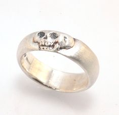 This is the widest of my Memento Mori skull rings at 7mm. Cast in sterling silver and given a brushed finish after oxidizing the recesses of the skull. Heavyweight, very comfortable.SterlingI made these Memento Mori rings for my older sister Jill, a famous poet and Professor who turned 50 this year. Well, I made the first one for her, the second because I wanted to make more knees, the third because I wanted to redo a jawbone. Skeletons are rad, even for nerds like me. And they look better the m Mori Jewelry, Memento Mori Skull, Memento Mori Jewelry, Memento Mori Ring, Hand Jewellery, Skull Rings, Famous Poets, Jaw Bone, Older Sister