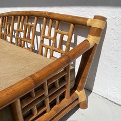 a close up of a wooden bench with cushions