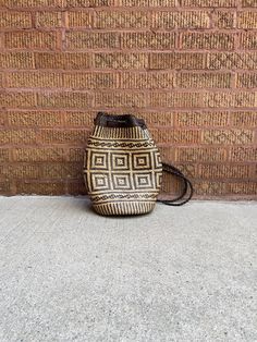 Vintage basket weave and leather sling purse. Braided leather straps. Lined in lightweight, pattered material. Minor signs of wear, in very good vintage condition.  Lightweight and cool for summer. Brown Woven Leather Basket Bucket Bag, Brown Woven Leather Bucket Bag, Woven Leather Bucket Shoulder Bag For Market, Brown Straw Backpack With Adjustable Strap, Weaving Bucket Bag For Travel, Traditional Woven Leather Shoulder Bag For Travel, Casual Bucket Shoulder Bag With Weaving, Vintage Bucket Bags With Braided Handles, Vintage Brown Woven Straw Bag