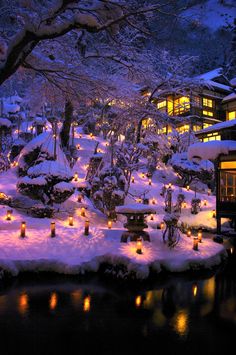 snow covered landscape with lit candles in the foreground