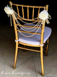 a chair decorated with pearls and flowers