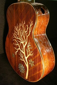 a wooden guitar with an intricate design on it