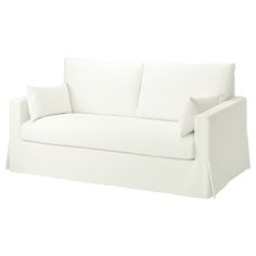 a white couch with two pillows on it