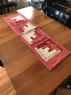 a wooden table with a red and white runner on it