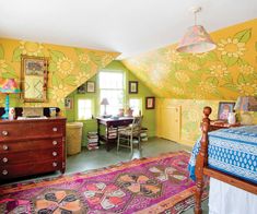 a bedroom with yellow walls and floral wallpaper on the ceiling is decorated in bright colors