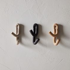 three wooden letters are hanging on the wall