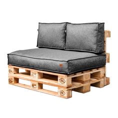 a couch made out of wooden pallets with black cushions on it's sides