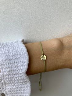 This simple silk cord bracelet looks great worn alone or stacked with other delicate pieces. Customise it by choosing the letter/symbol and disc of your choice. D E T A I L S *Choose between a gold filled/rose gold filled or sterling silver disc . These measure between 8 and 9mm. *Personalise it by adding an initial or a symbol. See photos for description. *And natural silk cord that has been twisted for strength. Cord measures 0.7mm. Finished piece is made with black silk but other options are available. *If the silk should arrive kinked it will straighten itself out after a few hours after coming into contact with your skin. *You can expect the ends to flare creating a pretty tassel.  *Bracelet comes with an explanatory card and is gift ready. C A R E * T I P Silk is a natural product wh Heart Peace Sign, Silk Cord Bracelet, Ankle Bracelets Diy, Silk Bracelet, Letter Symbols, Bracelets Diy, Tassel Bracelet, Silk Cord, Cord Bracelet