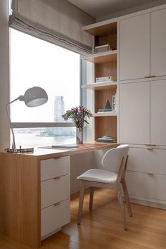 a desk and chair in front of a window