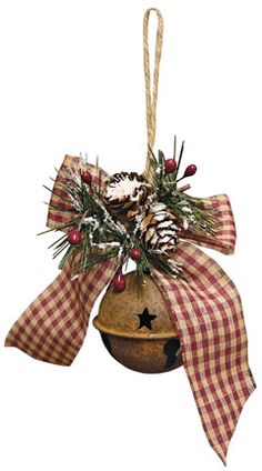 a christmas ornament with pine cones and berries hanging from it's side