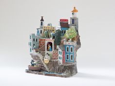 a small figurine of a city on a rock