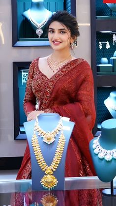 a woman standing in front of jewelry on display