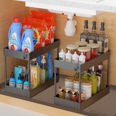 two metal containers filled with different types of cleaning products on top of a kitchen counter