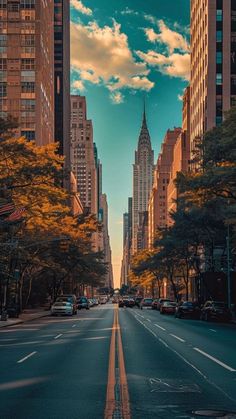 an empty city street with tall buildings in the background