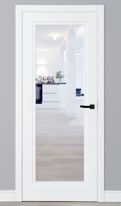 an open white door in a room with grey walls and wood flooring on the side