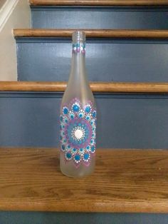 a glass bottle sitting on top of a wooden step