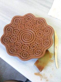 a cookie that is sitting on top of a table with a knife next to it