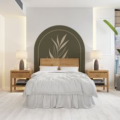 a bedroom with a bed, two nightstands and a plant wall decal on the wall