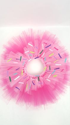 a pink tutu with sprinkles on it and a hole in the middle