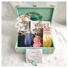 a gift box filled with personal items for someone's special occasion, including coffee mugs and cards