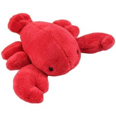 a red stuffed animal laying on top of a white surface