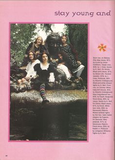 a group of people sitting on top of a log