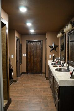 a bathroom with two sinks and mirrors on the wall next to each other in front of an open door