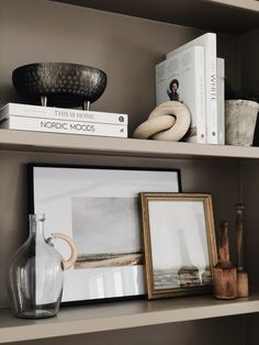 shelves with books, vases and pictures on them