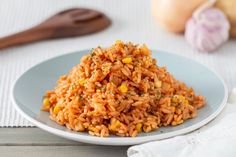 a white plate topped with rice and vegetables