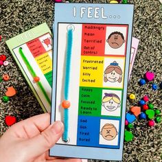 a person holding up a book about feelings and feelings in front of candy candies