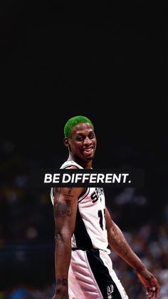 a man with green hair is smiling and wearing a basketball uniform that says be different