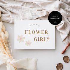 a flower girl card next to some flowers and coins on a white surface with the words, what's your day?