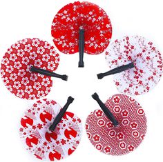 six red and white flowered paper umbrellas with black pins in the middle on a white background