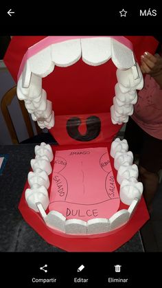 a red box with white teeth in it and the words dulce written on it