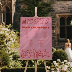 a pink sign with writing on it in front of a bride and her wedding dress