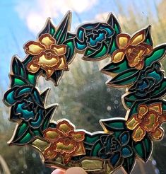 a close up of a person holding a stained glass wreath