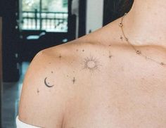 a woman's chest with stars and the moon on it