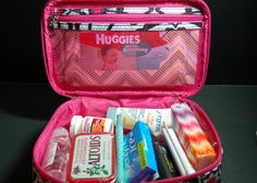 a pink suitcase filled with personal care items