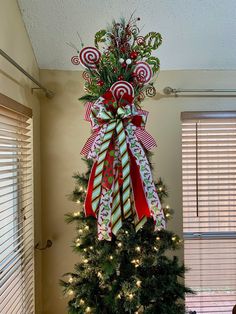 a christmas tree decorated with candy canes and bows