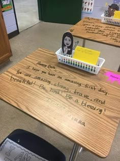 a wooden desk with writing on it