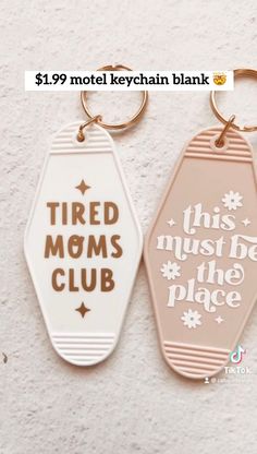 two key chains that say tired moms club