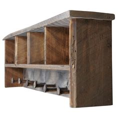 a wooden shelf with metal hooks on the top and two shelves below it that are made out of wood