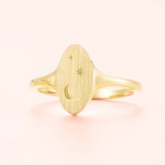 Adorn your finger with the Celestial Signet Ring, a unique and inspiring piece crafted in 14k gold or silver. Featuring a striking moon and stars motif, this celestial ring is a piece of art that reflects your own unique style and shines with high-quality. Make a statement with this stunning accessory!RING LAYOUT  Ring Width: 13 mm tapered to 2 mm Ring Sleeve:14KGold or Sterling Silver Ring Profile:Round Ring Finish:Brushed Top, Polished Shank