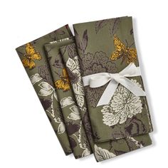 three napkins with flowers and butterflies on them