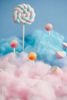 cotton candy lollipops and other candies on top of clouds