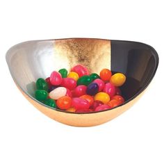 a bowl filled with gummy bears sitting on top of a table