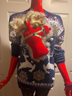 a mannequin dressed in christmas sweaters and leggings with decorations on it