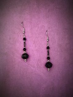 Elevate your gothic Victorian style with these stunning black facetted bead and silver dangle earrings. The intricate design of these earrings captures the essence of a bygone era, combining the dark elegance of gothic fashion with the intricate details of Victorian style. Perfect for adding a touch of drama to any outfit, these earrings are sure to make a statement wherever you go. Handcrafted with care and attention to detail, these earrings are a unique and stylish addition to your jewelry co Black Faceted Bead Earrings For Gift, Black Faceted Beads Earrings For Gift, Black Faceted Bead Drop Earrings, Black Faceted Beads Earrings For Party, Black Faceted Beaded Drop Earrings, Elegant Black Beaded Earrings With Faceted Beads, Black Metal Round Beads Earrings, Black Metal Earrings With Round Beads, Nickel-free Black Beaded Drop Earrings